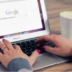 Person using a laptop to search Google as part of researching and comparing businesses online.